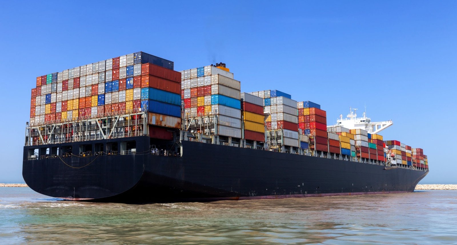 megaship with containers on board sailing in ocean